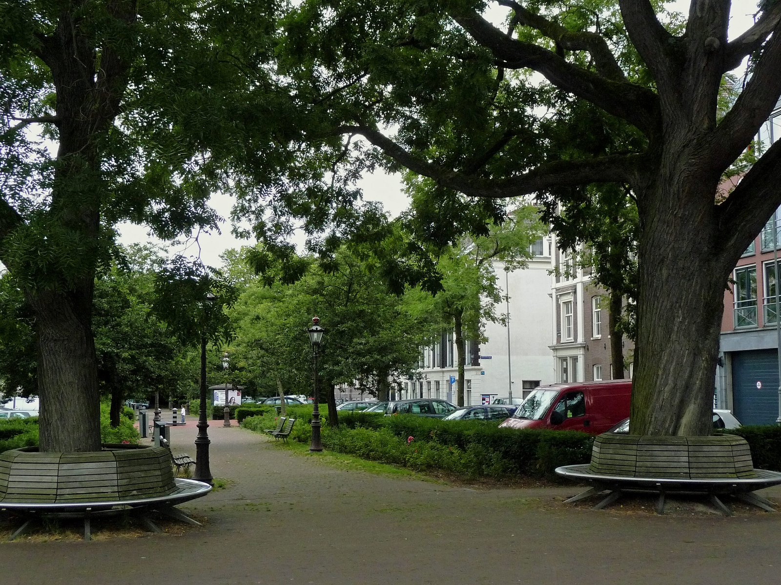 Photo of summer in urban park on the square Frederiksplein in Amsterdam city; under the big trees are benches to relax. Photo july 2009 by photographer Fons Heijnsbroek - free download